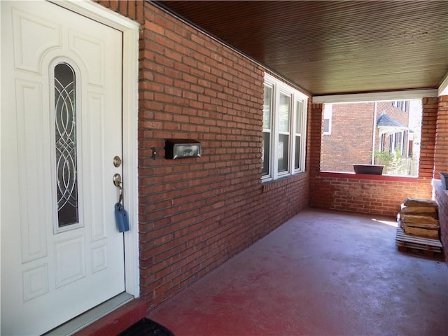 437 Green St, Munhall, PA 15120 - property entrance with brick siding and covered porch