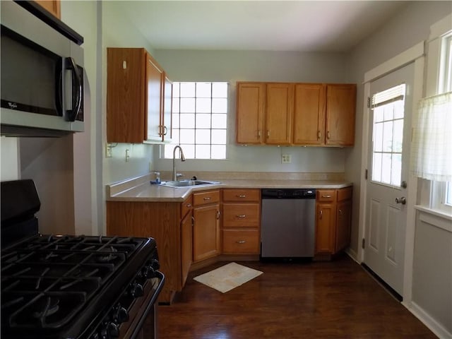 437 Green St, Munhall, PA 15120 - kitchen featuring stainless steel appliances, light countertops, healthy amount of natural light, and dark wood-style floors
