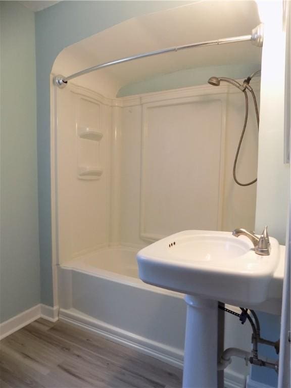 437 Green St, Munhall, PA 15120 - full bathroom with wood finished floors and tub / shower combination