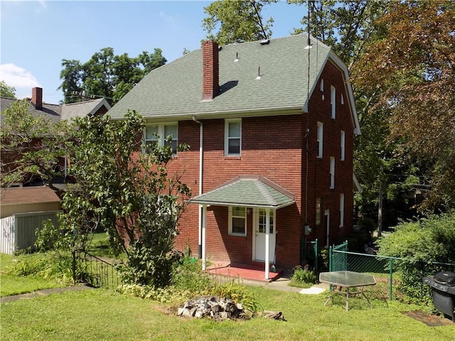 437 Green St, Munhall, PA 15120 - rear view of house featuring a chimney, roof with shingles, and brick siding
