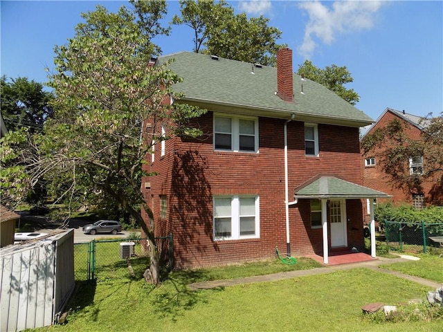 437 Green St, Munhall, PA 15120 - rear view of property featuring a chimney, brick siding, roof with shingles, and a gate