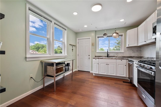 637 Bigelow St, Greenfield, PA 15207 - kitchen with appliances with stainless steel finishes, dark wood-style flooring, white cabinets, recessed lighting, and decorative backsplash
