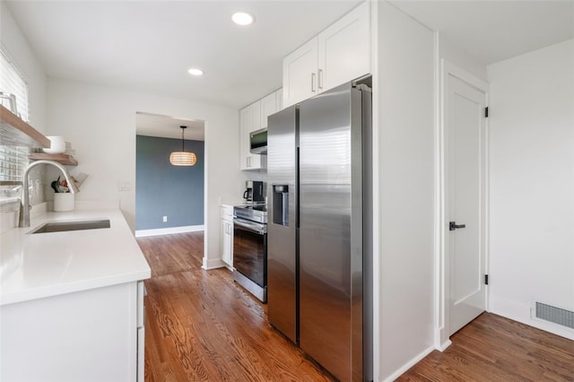 300 Jacks Run Rd, Ross Twp, PA 15202 - kitchen featuring stainless steel appliances, wood finished floors, white cabinetry, light countertops, and recessed lighting