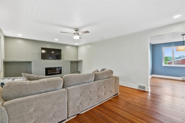300 Jacks Run Rd, Ross Twp, PA 15202 - living area featuring wood finished floors, a glass covered fireplace, a ceiling fan, and recessed lighting
