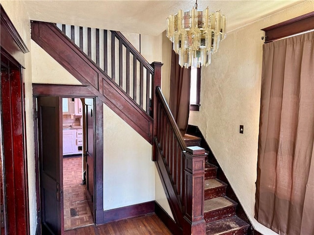 1413 Summit Ave, Monessen, PA 15062 - stairs with a textured wall, a chandelier, and wood finished floors