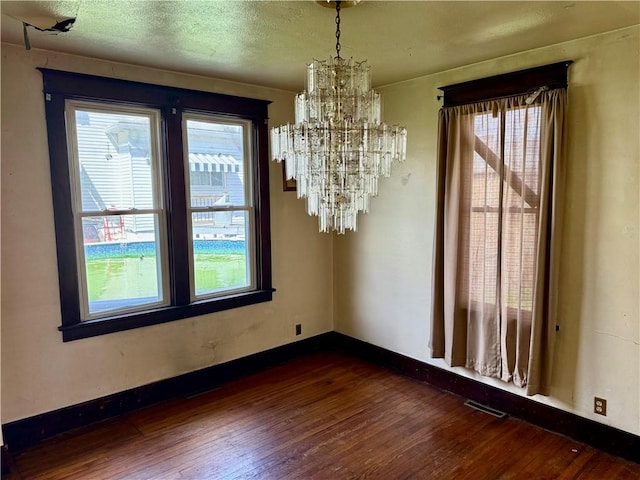 1413 Summit Ave, Monessen, PA 15062 - unfurnished dining area featuring dark wood finished floors and a chandelier