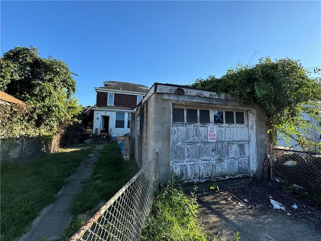 1413 Summit Ave, Monessen, PA 15062 - view of front facade featuring concrete block siding and a detached garage