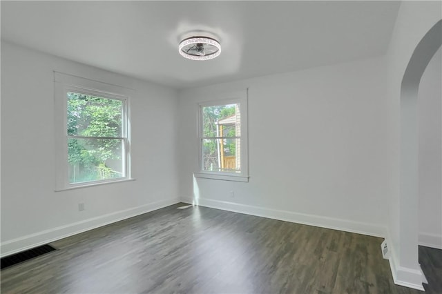 1311 Irwin St, Aliquippa, PA 15001 - empty room with arched walkways and dark wood-style flooring