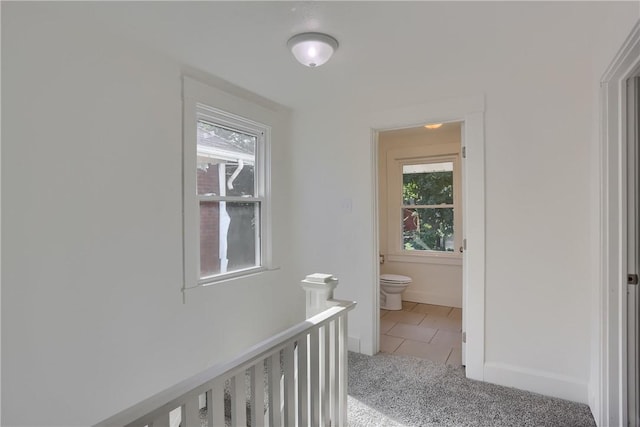 1311 Irwin St, Aliquippa, PA 15001 - corridor featuring light tile patterned flooring, light colored carpet, and an upstairs landing