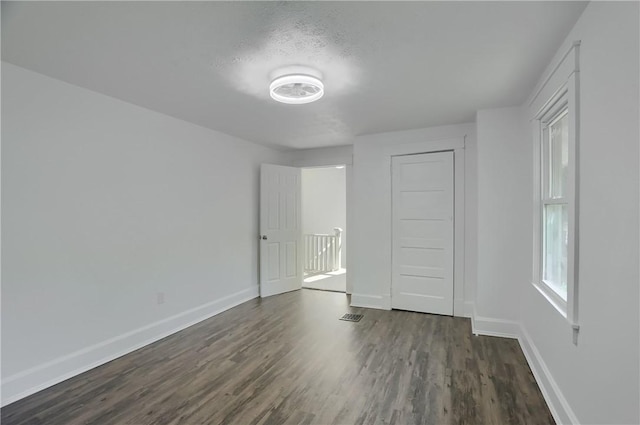 1311 Irwin St, Aliquippa, PA 15001 - unfurnished bedroom with baseboards and dark wood-type flooring