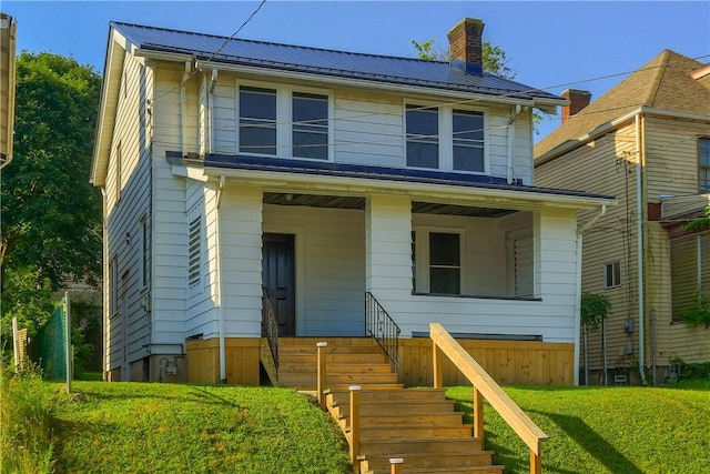 1311 Irwin St, Aliquippa, PA 15001 - view of front of home featuring a chimney, a metal roof, and a front yard