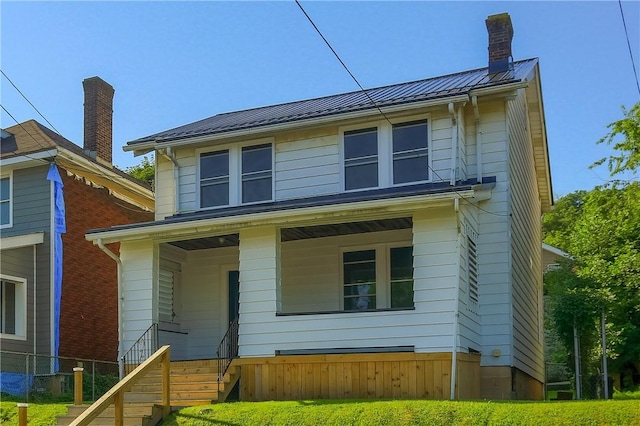 1311 Irwin St, Aliquippa, PA 15001 - view of front facade with a standing seam roof, a porch, a metal roof, a chimney, and stairway