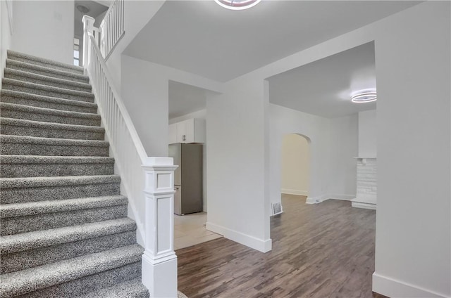 1311 Irwin St, Aliquippa, PA 15001 - staircase featuring arched walkways and wood finished floors