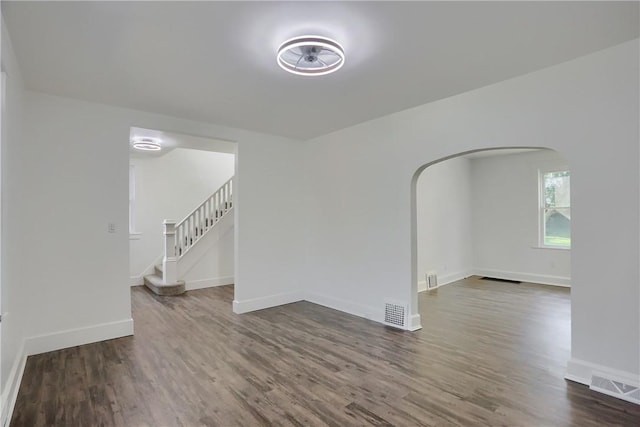 1311 Irwin St, Aliquippa, PA 15001 - unfurnished room with arched walkways, wood finished floors, and stairs