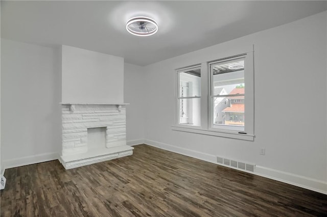 1311 Irwin St, Aliquippa, PA 15001 - unfurnished living room featuring dark wood-type flooring and a stone fireplace