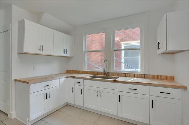 1311 Irwin St, Aliquippa, PA 15001 - kitchen with wooden counters, white cabinets, and light tile patterned floors