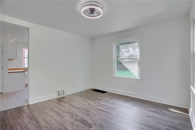 1311 Irwin St, Aliquippa, PA 15001 - empty room featuring plenty of natural light and wood finished floors