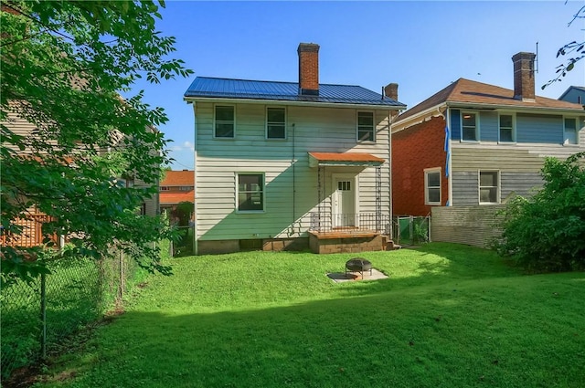1311 Irwin St, Aliquippa, PA 15001 - rear view of house featuring a standing seam roof, a chimney, and a metal roof