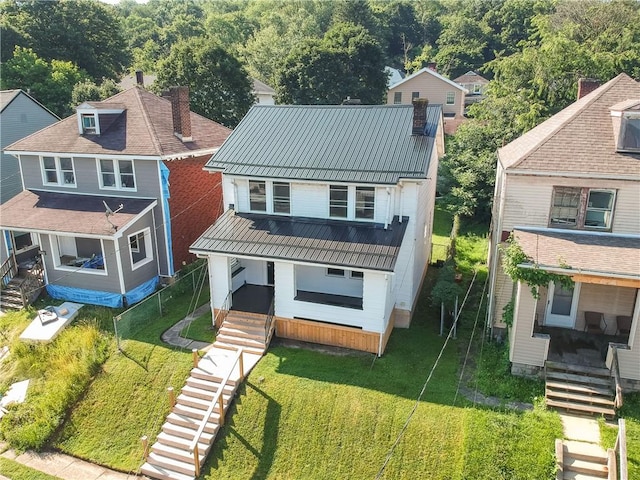 1311 Irwin St, Aliquippa, PA 15001 - view of front facade with a metal roof, a front yard, and covered porch