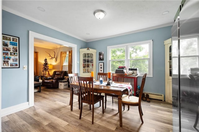 103 Lackawana Ave, Bentleyville, PA 15314 - dining room featuring baseboard heating, crown molding, light wood-style flooring, and an office area