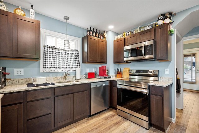 103 Lackawana Ave, Bentleyville, PA 15314 - kitchen featuring appliances with stainless steel finishes, light wood finished floors, dark brown cabinetry, light stone counters, and recessed lighting
