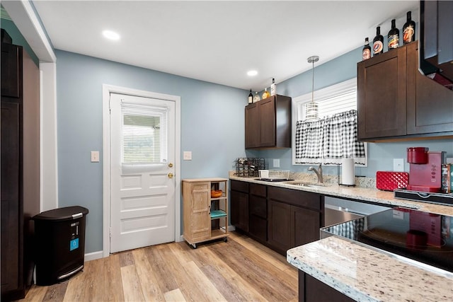 103 Lackawana Ave, Bentleyville, PA 15314 - kitchen featuring healthy amount of natural light, dark brown cabinetry, light wood-style floors, pendant lighting, and recessed lighting