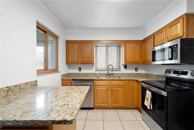 708 Washington St, Bentleyville, PA 15314 - kitchen with stainless steel appliances, brown cabinets, ornamental molding, light stone counters, and light tile patterned floors