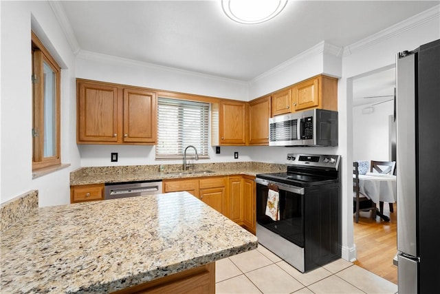 708 Washington St, Bentleyville, PA 15314 - kitchen featuring stainless steel appliances, ornamental molding, light stone countertops, light tile patterned floors, and brown cabinets