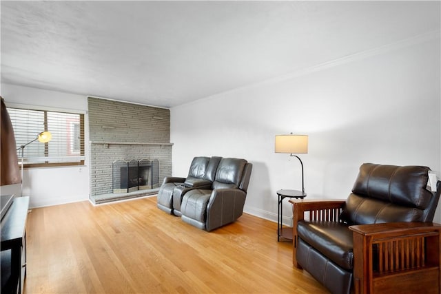 708 Washington St, Bentleyville, PA 15314 - living room featuring wood finished floors, a brick fireplace, and crown molding