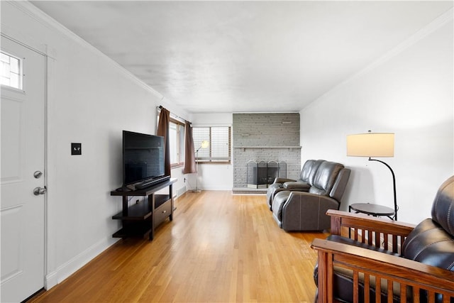 708 Washington St, Bentleyville, PA 15314 - living area featuring plenty of natural light, light wood-style flooring, a fireplace, and crown molding