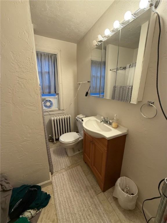 2306 Sherbrook St, Squirrel Hill, PA 15217 - bathroom with radiator, a textured wall, vanity, a textured ceiling, and a shower with curtain