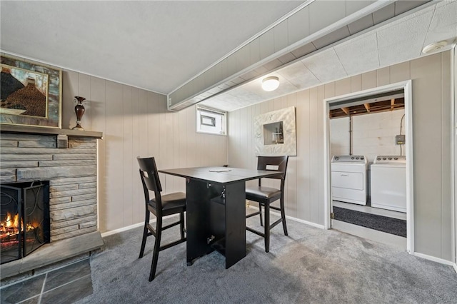 249 Laurie Dr, Penn Hills, PA 15235 - carpeted dining room with washer and clothes dryer, a stone fireplace, and wooden walls