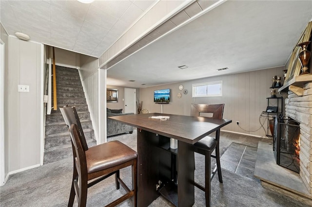 249 Laurie Dr, Penn Hills, PA 15235 - dining area featuring stairs, a fireplace, and dark colored carpet