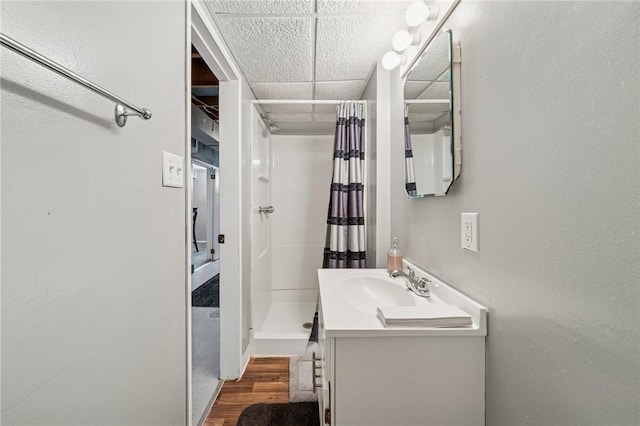 249 Laurie Dr, Penn Hills, PA 15235 - bathroom with a stall shower, vanity, a drop ceiling, and wood finished floors