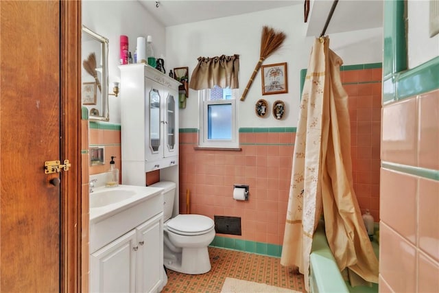 200 Champa St, Penn Hills, PA 15235 - bathroom with tile walls, tile patterned floors, vanity, wainscoting, and shower / bath combo with shower curtain