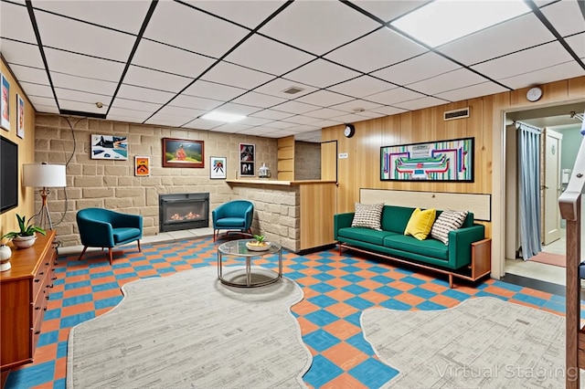 200 Champa St, Penn Hills, PA 15235 - living area featuring a drop ceiling, a glass covered fireplace, and wood walls