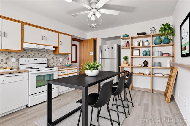 200 Champa St, Penn Hills, PA 15235 - kitchen with electric stove, under cabinet range hood, light wood-style floors, and decorative backsplash