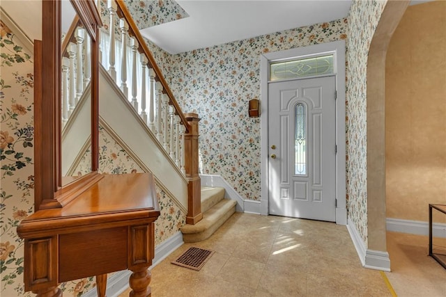 488 Buffalo St, Beaver, PA 15009 - foyer entrance featuring wallpapered walls, arched walkways, and stairs