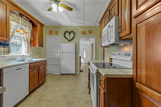 488 Buffalo St, Beaver, PA 15009 - kitchen with white appliances, a drop ceiling, brown cabinetry, light countertops, and wallpapered walls