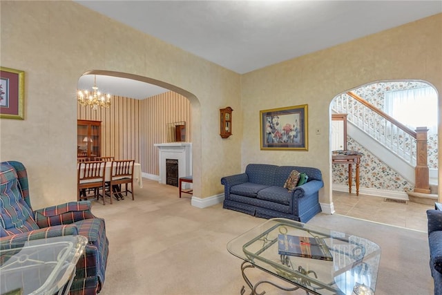 488 Buffalo St, Beaver, PA 15009 - living room featuring arched walkways, wallpapered walls, a chandelier, stairway, and a fireplace