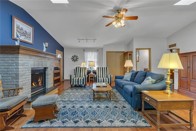 488 Buffalo St, Beaver, PA 15009 - living room with wood finished floors, vaulted ceiling, a skylight, a fireplace, and a ceiling fan