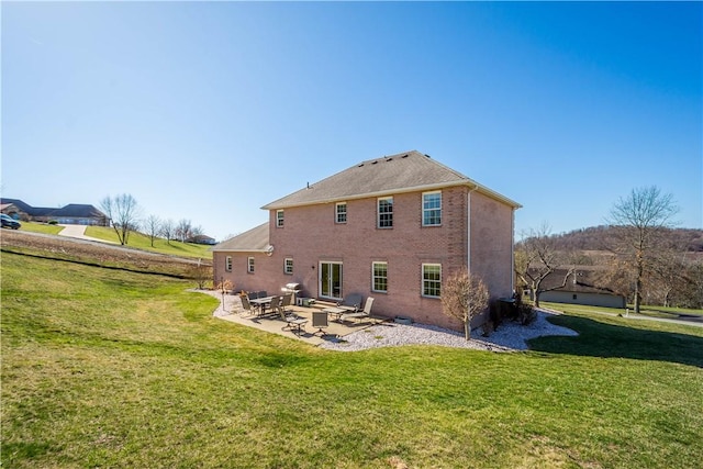 138 Crossridge Rd, Fallowfield, PA 15022 - back of house featuring a patio area, a lawn, and brick siding