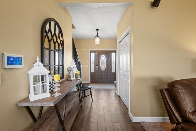 138 Crossridge Rd, Fallowfield, PA 15022 - foyer entrance with dark wood finished floors, stairway, and a textured ceiling