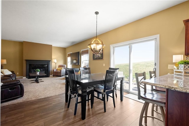 138 Crossridge Rd, Fallowfield, PA 15022 - dining room featuring a glass covered fireplace, wood finished floors, and a chandelier