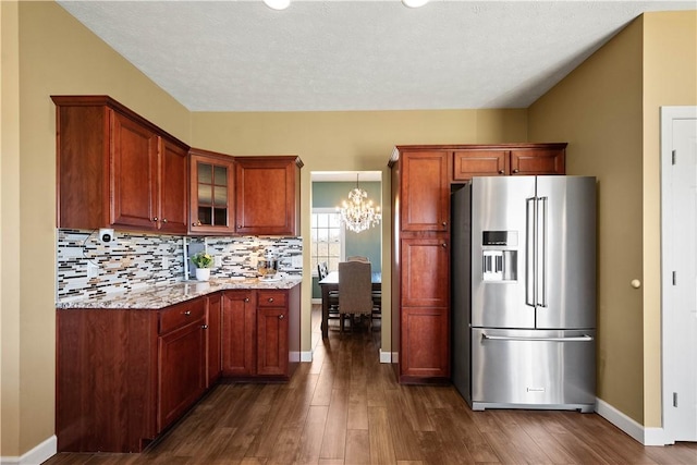 138 Crossridge Rd, Fallowfield, PA 15022 - kitchen with high end refrigerator, dark wood-style flooring, light stone countertops, a chandelier, and glass insert cabinets