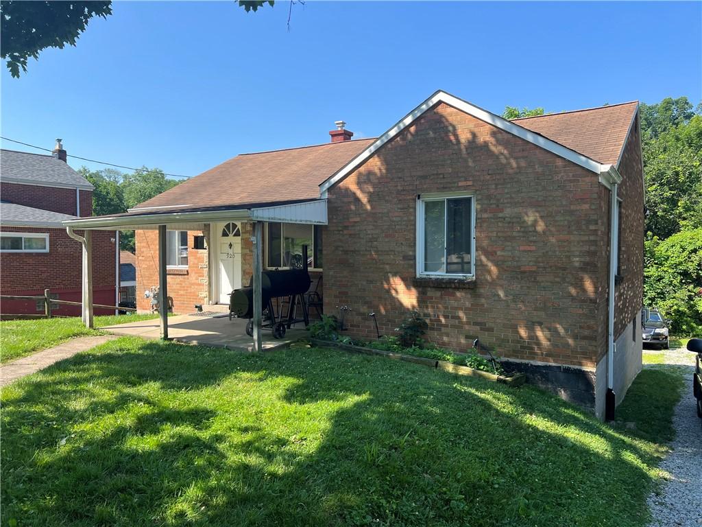 920 Jefferson Rd, Penn Hills, PA 15235 - view of front facade featuring a patio, brick siding, and a chimney
