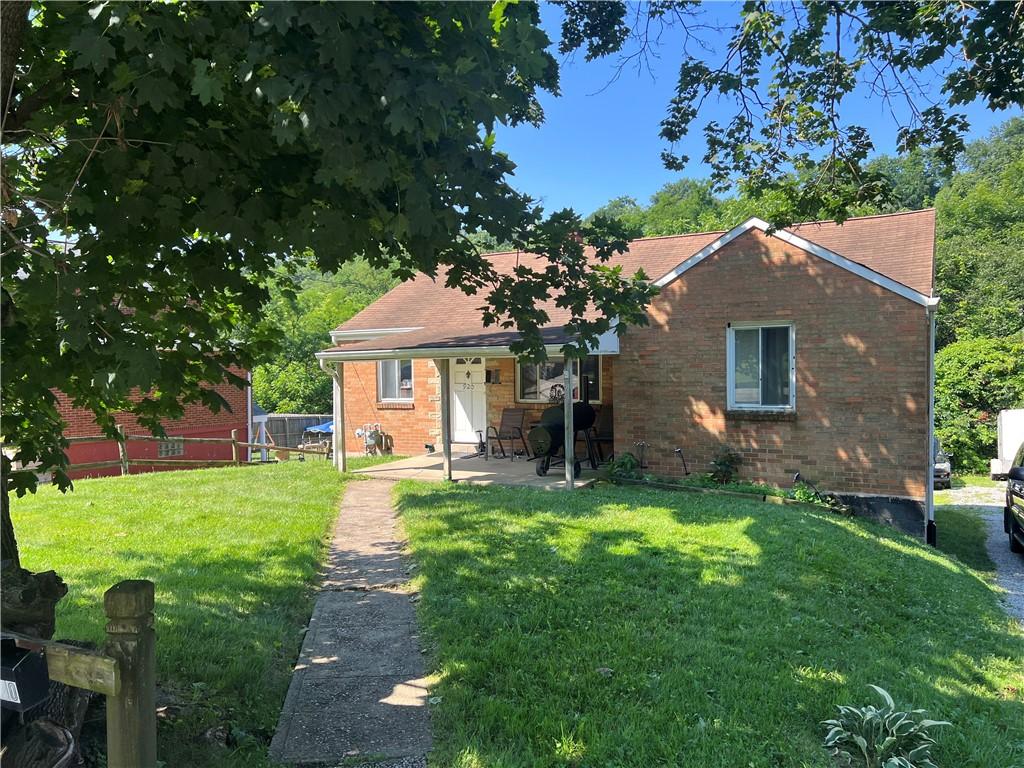 920 Jefferson Rd, Penn Hills, PA 15235 - view of front facade featuring brick siding, a front yard, and a patio