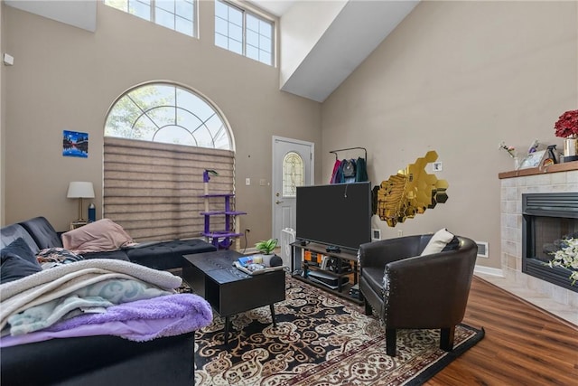 302 Malcolm Ct, Monroeville, PA 15146 - living area featuring a towering ceiling, wood finished floors, and a tiled fireplace