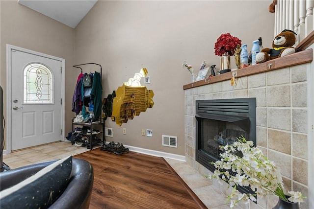 302 Malcolm Ct, Monroeville, PA 15146 - entrance foyer featuring a tile fireplace, vaulted ceiling, and light wood-type flooring