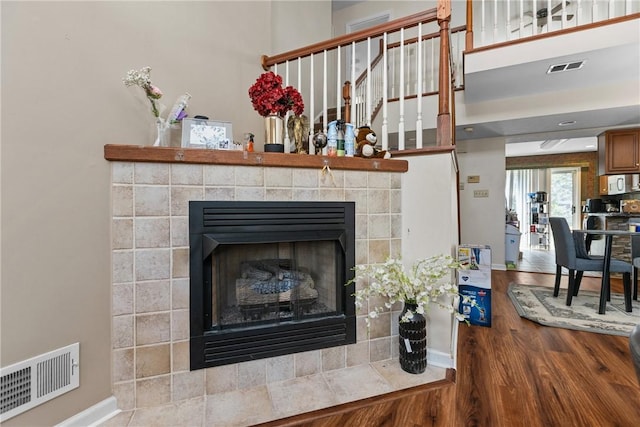 302 Malcolm Ct, Monroeville, PA 15146 - detailed view of a tiled fireplace, wood finished floors, and white microwave